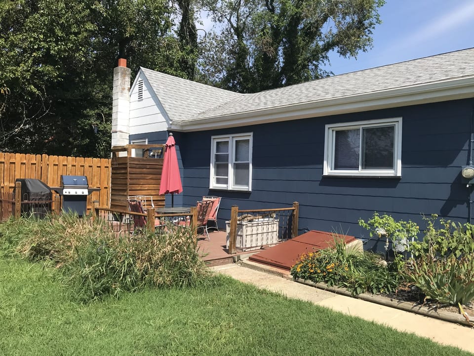 Backyard.  Patio area, outdoor shower, grill.