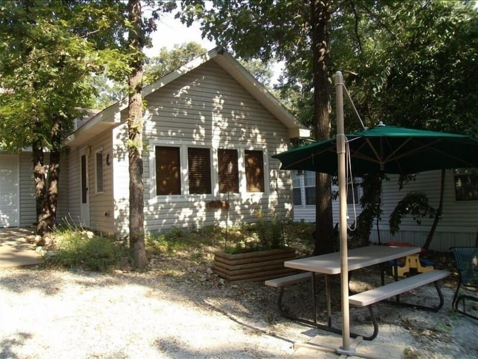 Tree Shaded Cabin with picnic table and fire-pit with lake view.