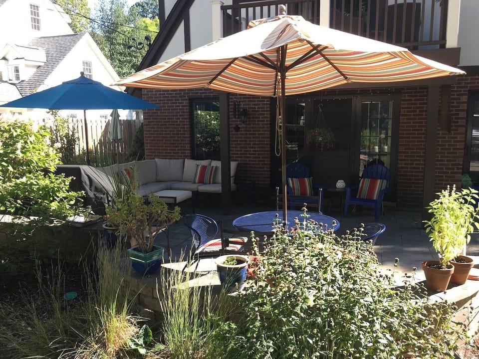 Full photo of patio (sitting and eating area) and 2nd floor balcony.