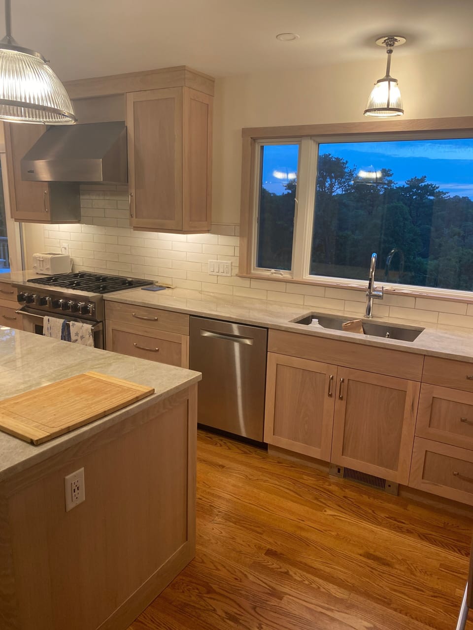 Large window in kitchen with view of backyard