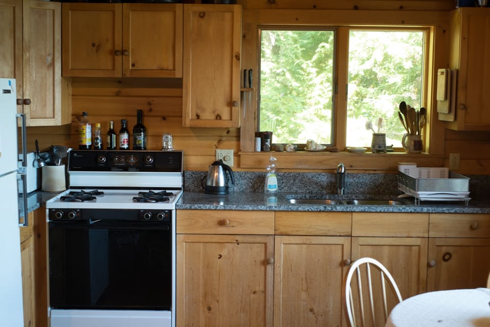 Kitchen showing granite counter, sink, and stove