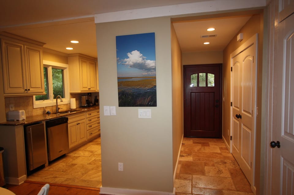 Entryway featuring  laundry area with large capacity washer and dryer.