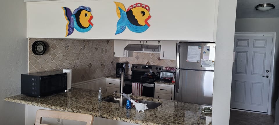 Looking into kitchen from dining room and bar