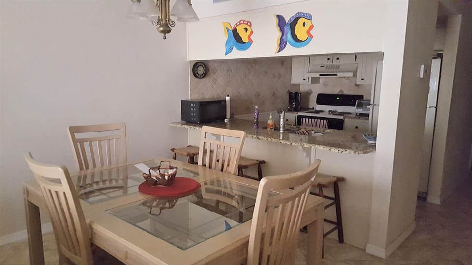 Kitchen with bar, microwave, coffee maker, toaster oven, mixers, oven, frig