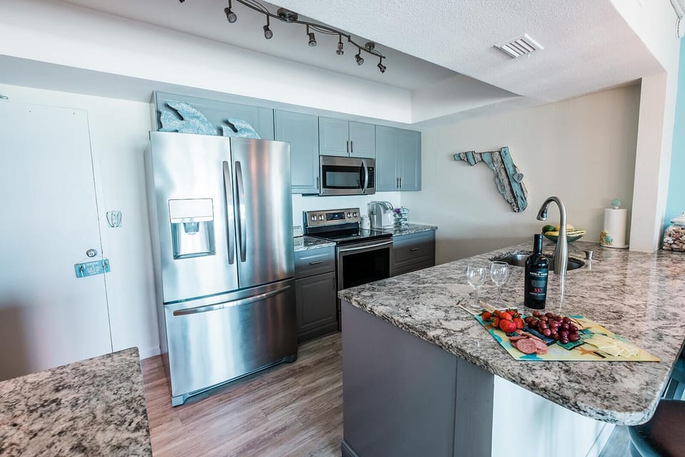 Fully equipped ocean-front kitchen with breakfast bar for easy meals.