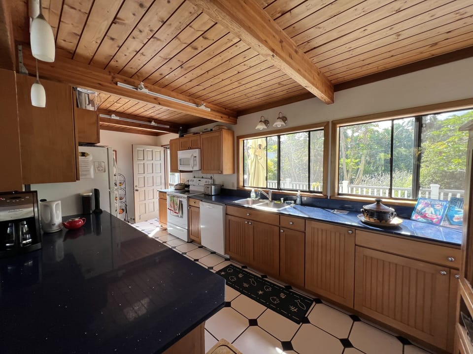 Kitchen with center island, stove, dishwasher, microwave, refrigerator