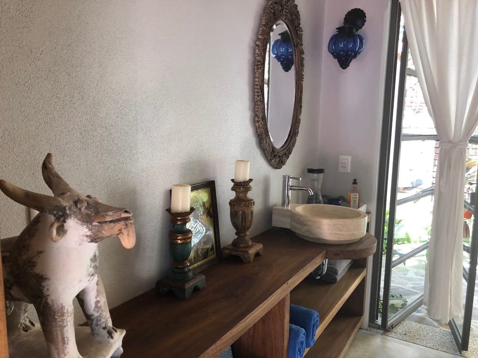 Clay art pieces, blown glass, stone sinks and candles in each private room. 