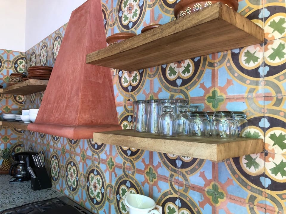 Large shelves with dishes, cookware, full size oven/stove and full size fridge. 