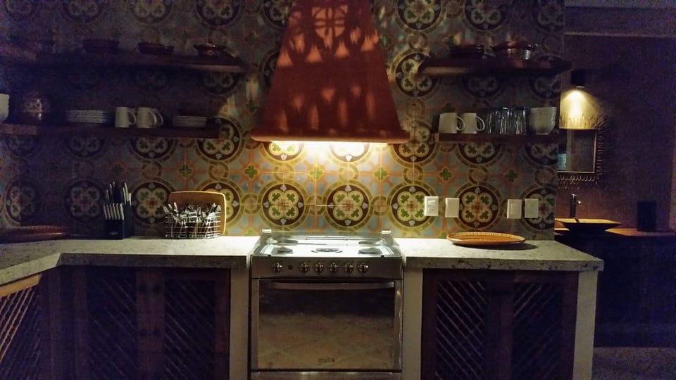 Evening view of incredible kitchen area, complete with custom handmade wall tile