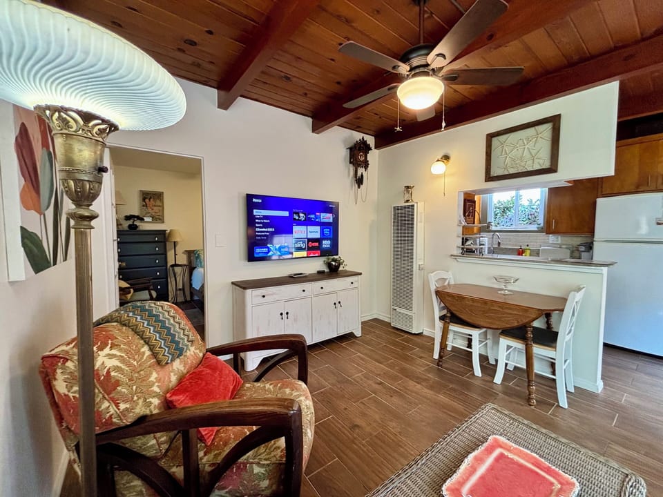 Livingroom with large TV - Ceiling fan - windows, dining area and full kitchen. 