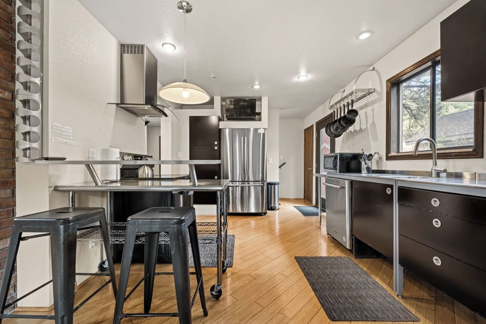 Fully stocked kitchen with stainless countertops, appliances, spices, dishware