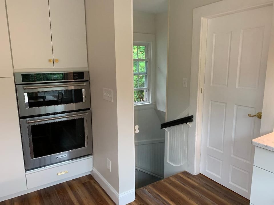 stairs leading to the laundry room. Convection oven and microwave.