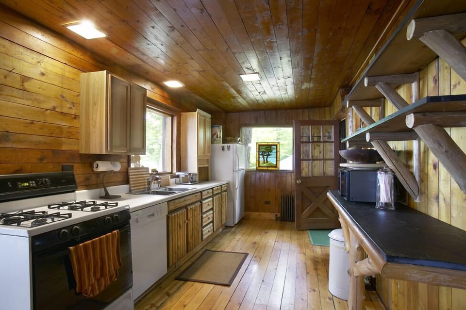 Simple galley kitchen with adjoining half bath.