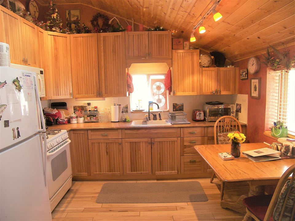 Kitchen is fully stocked with cookware, cutlery, Refrig, gas stove, coffee pot +