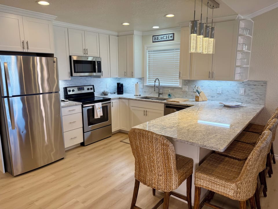 Hugh end remodeled kitchen. Granite, extra seating and fully stocked