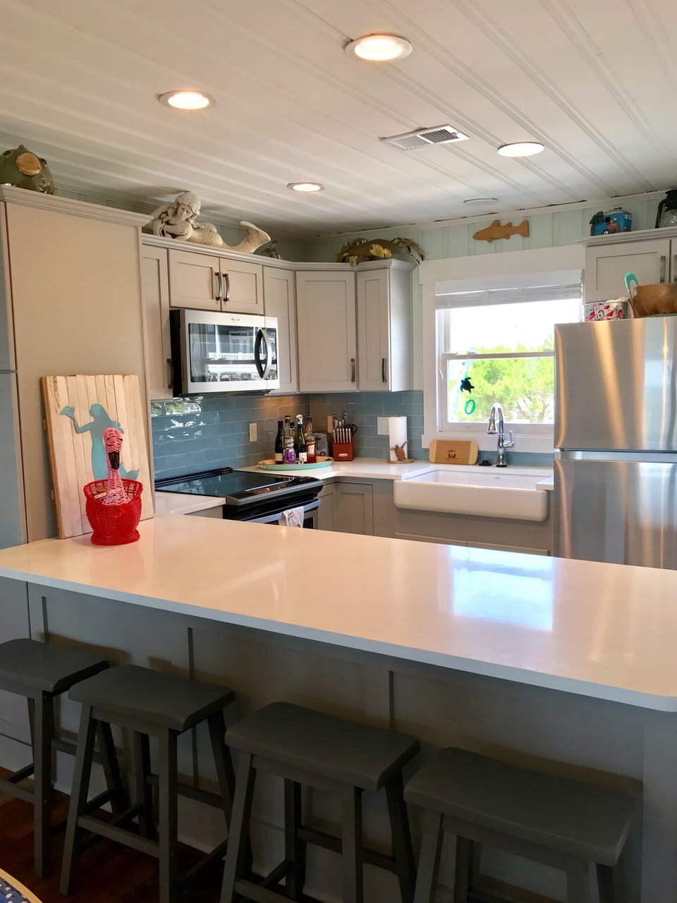 Quartz Countertops and bar stools offer comfortable dining or kitchen socials