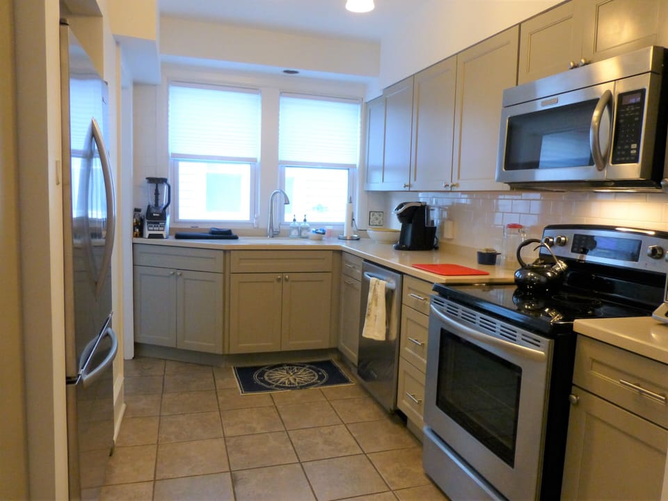 Kitchen. With stairs down to basement and side entrance.