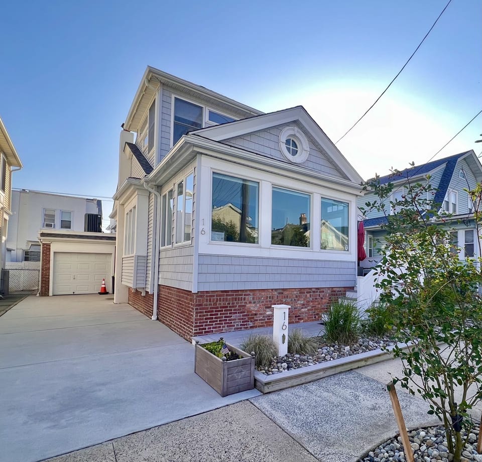 Driveway parking for 2-3 cars. Secure bikes, beach chairs, boards in garage.