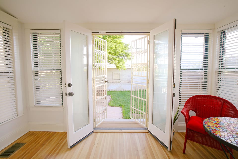 French doors from the Sun Room looking out to the back courtyard, gas grill too!