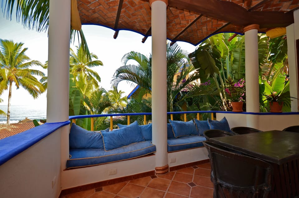 1 of the 3 Terraces overlooking the ocean with comfy cushions and outdoor