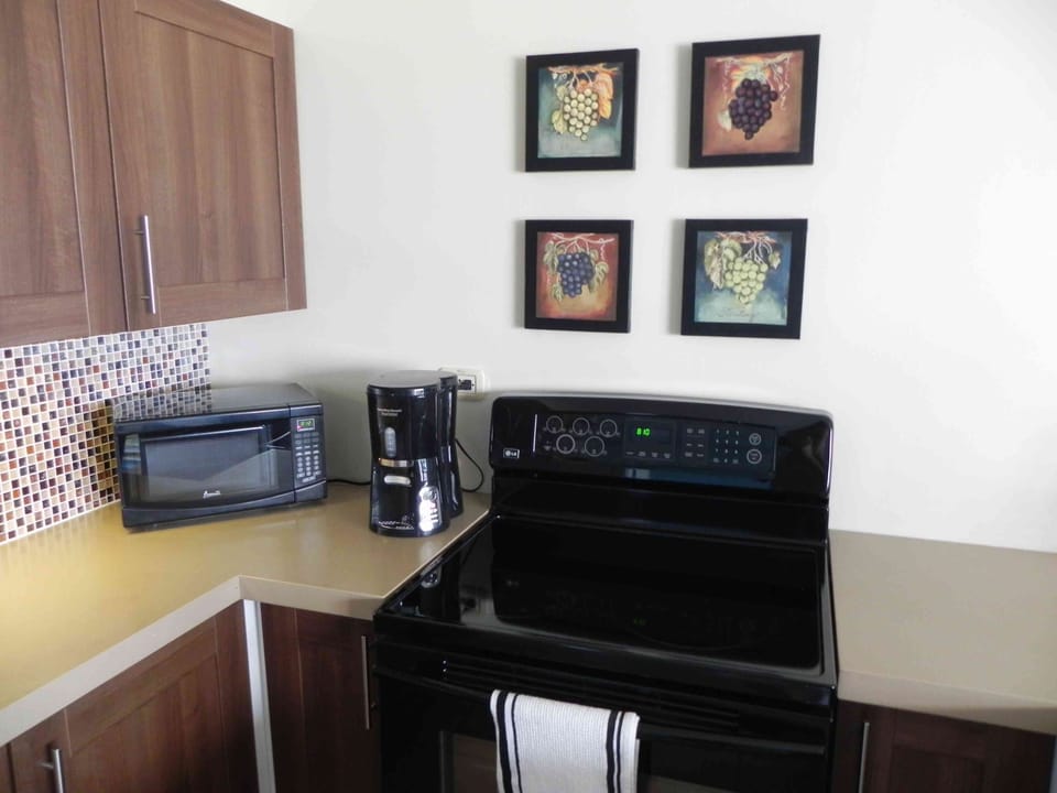 New kitchen stove, microwave, and coffee-maker. Other appliances are there too