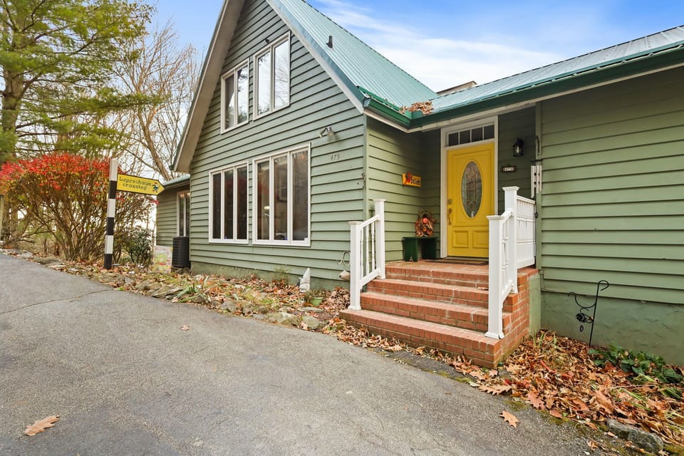 The front door is at the top of the driveway.