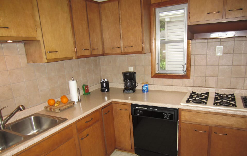 Kitchen with new backsplash, countertop and sink 