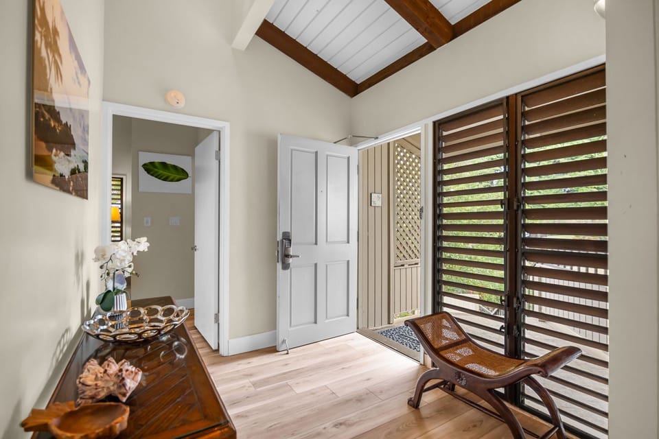 Enjoy a bright foyer featuring vaulted ceilings, wood accents, and stylish décor that sets the tone for the home.