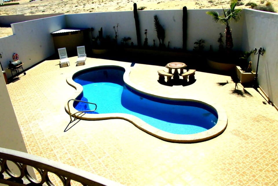 Crystal clear pool with custom tile and outside table and benches, enjoy!