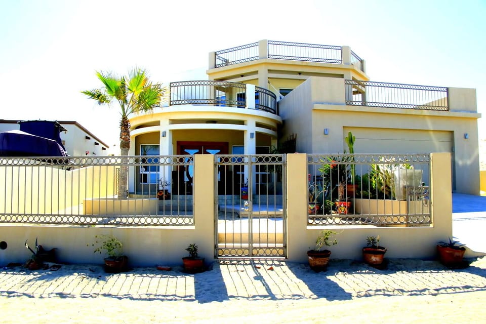 Mediterranean style three bedroom home with fenced front yard with private pool.