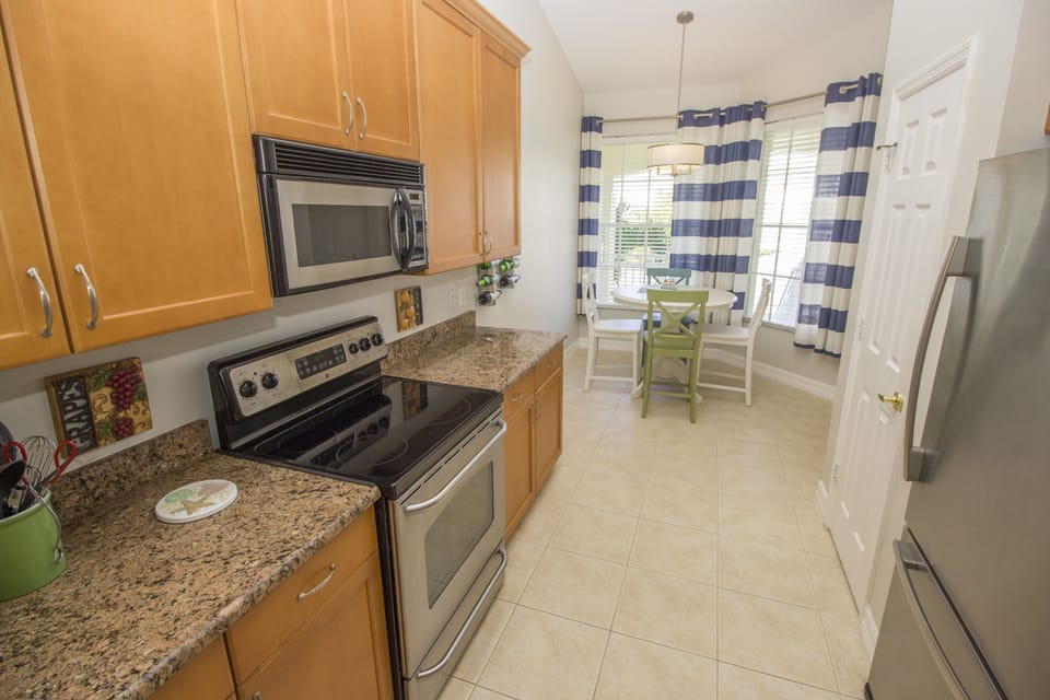 Kitchen also includes stove, refrigerator, dishes, flatware, and great views
