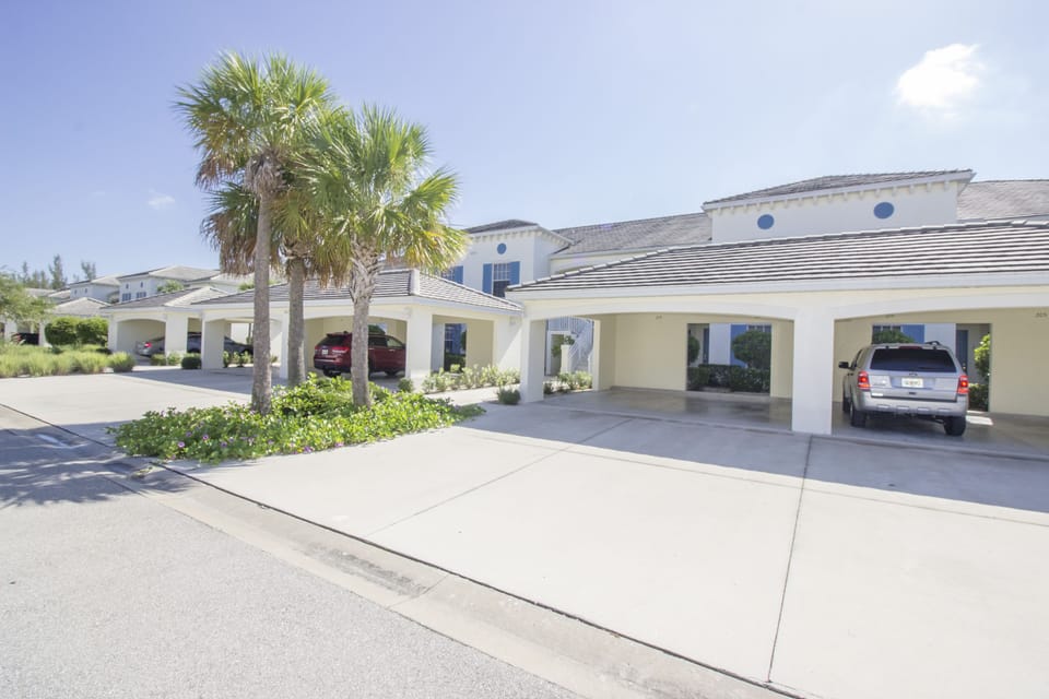 Carport immediately outside of condo with parking available for two cars