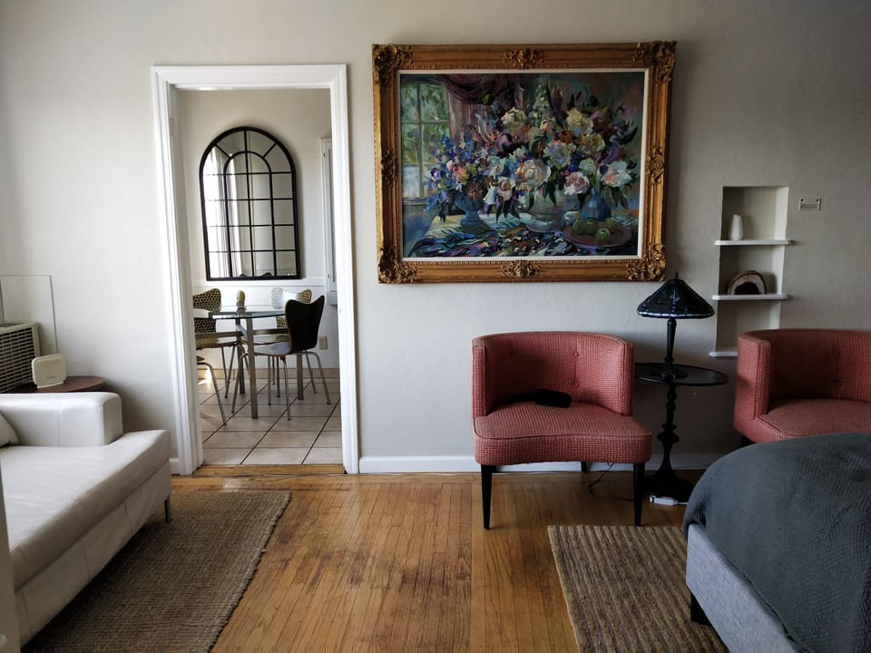 Serene apartment with wood floors and rugs. 