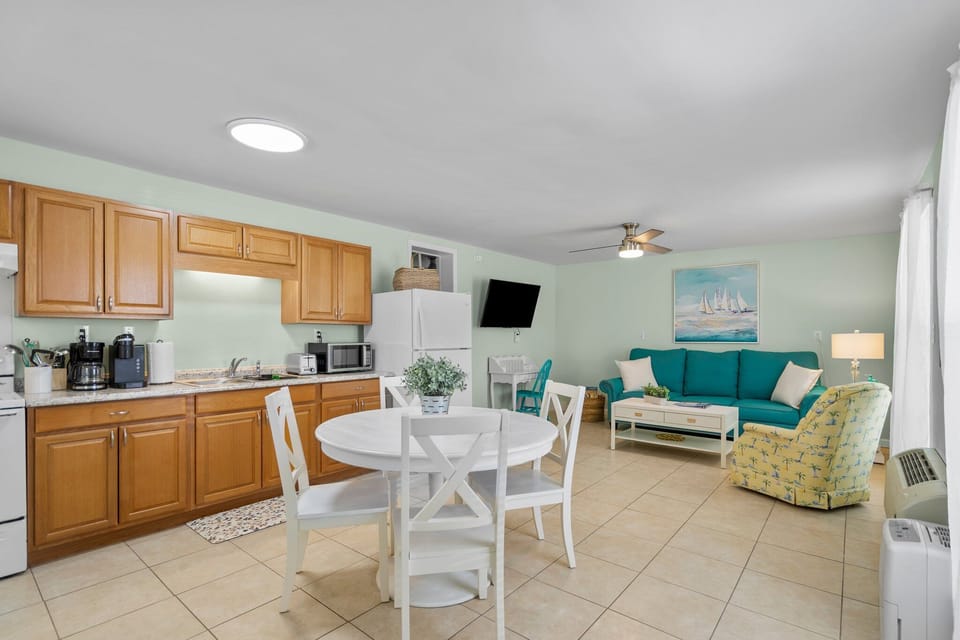 Your open-concept space blends kitchen and living areas perfectly, where you can cook, dine, and relax in comfort with coastal-inspired décor.