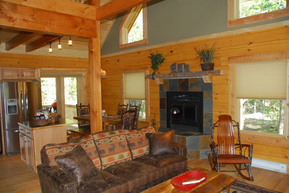 View from stair landing toward open living and dining areas