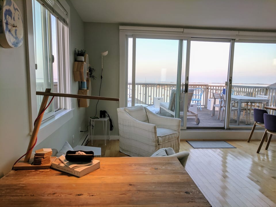 view from desk, through sitting area out to deck.