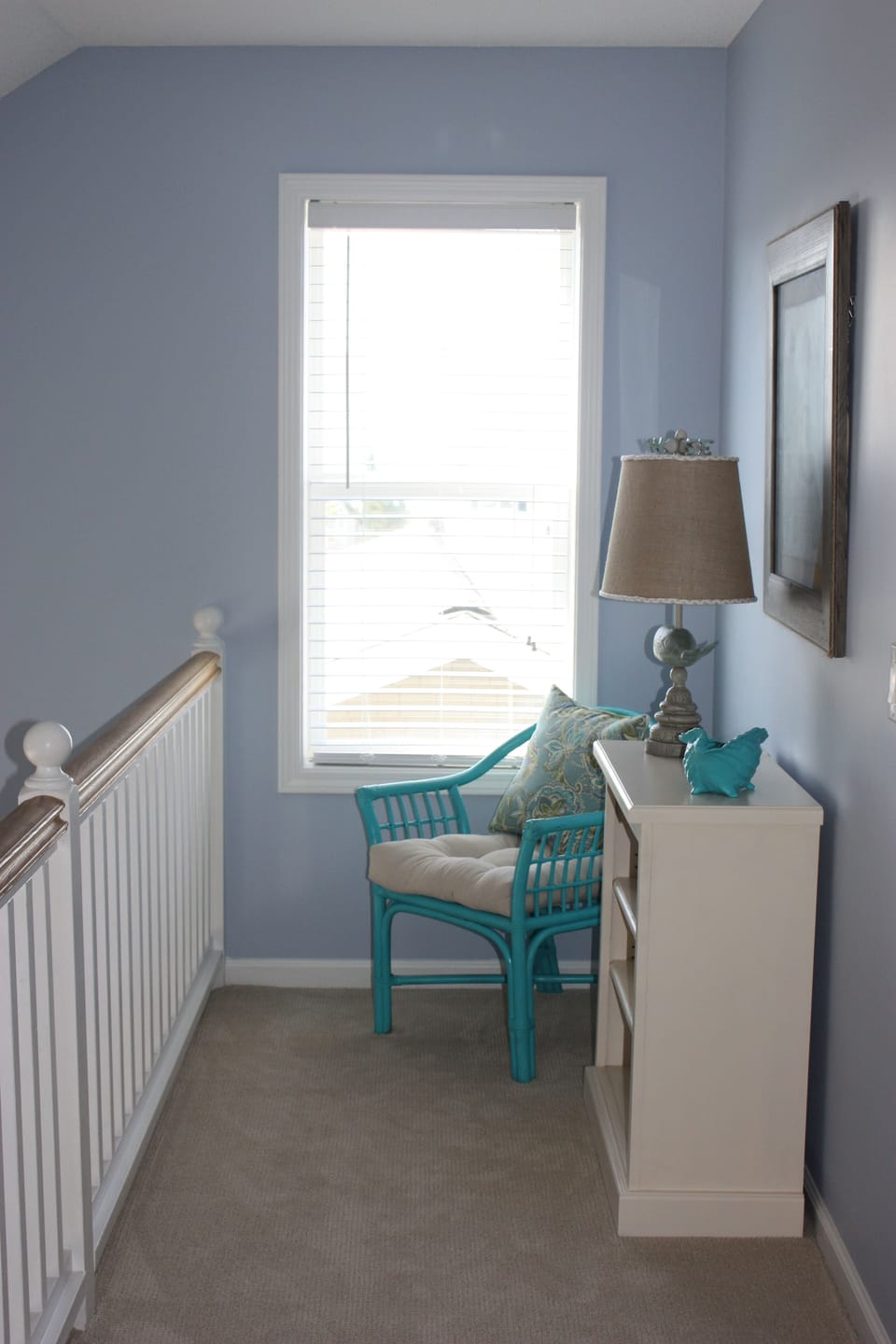 Upstairs hallway loft with seating and ocean view