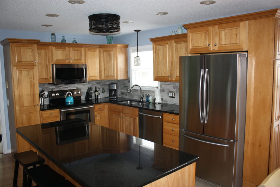 Gourmet Kitchen w/ all stainless appliances, granite counter tops, tiled floors