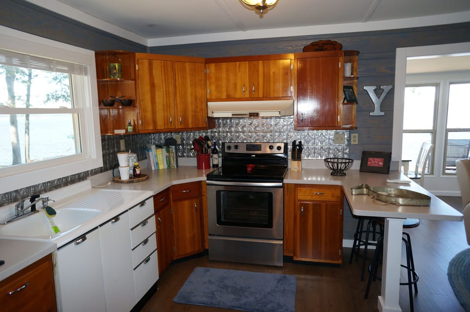 Kitchen area, new countertops, retained cabinets and porcelain sink.  
