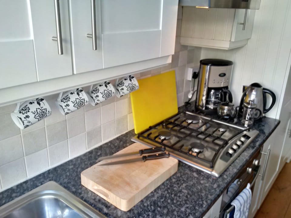 Gas hob, coffee makers,  fan oven, fridge/freezer, crockery/cutlery, food stores