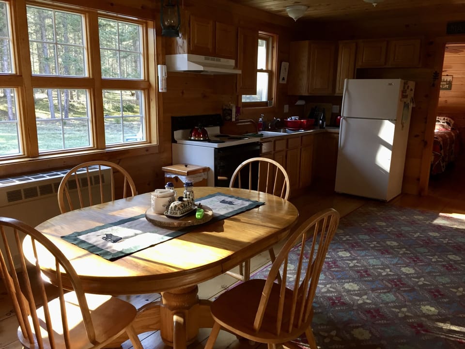 Dining area, kitchen, windows look out to front yard.