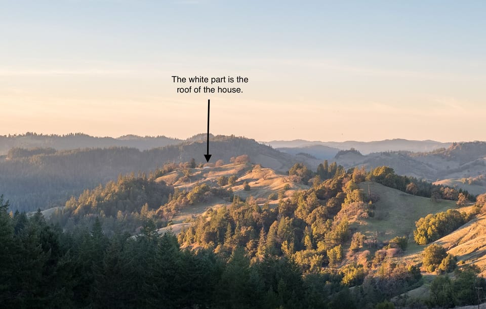 White roof is the ranch house nestled into surrounding ranch land.