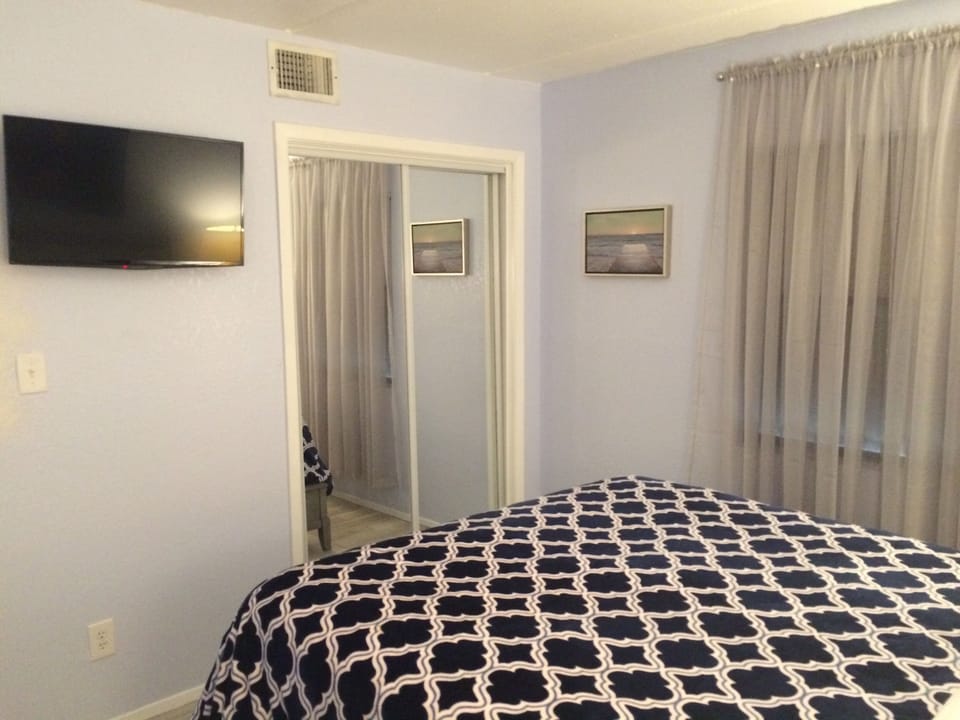 Bedroom closet full-length mirrors and wall mounted Roku TV