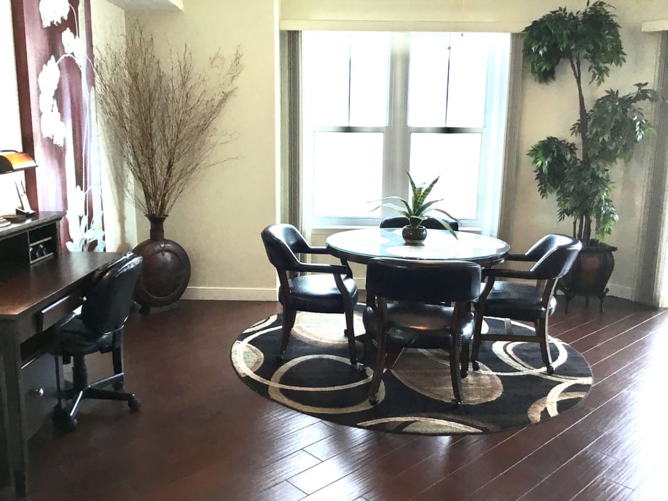 Dining room adjacent to living room with dramatic view of balcony and beach!