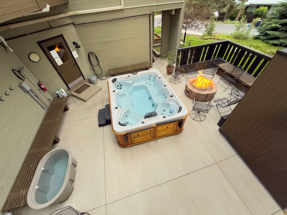 • Relaxing hot tub courtyard with fire pit and comfortable seating
