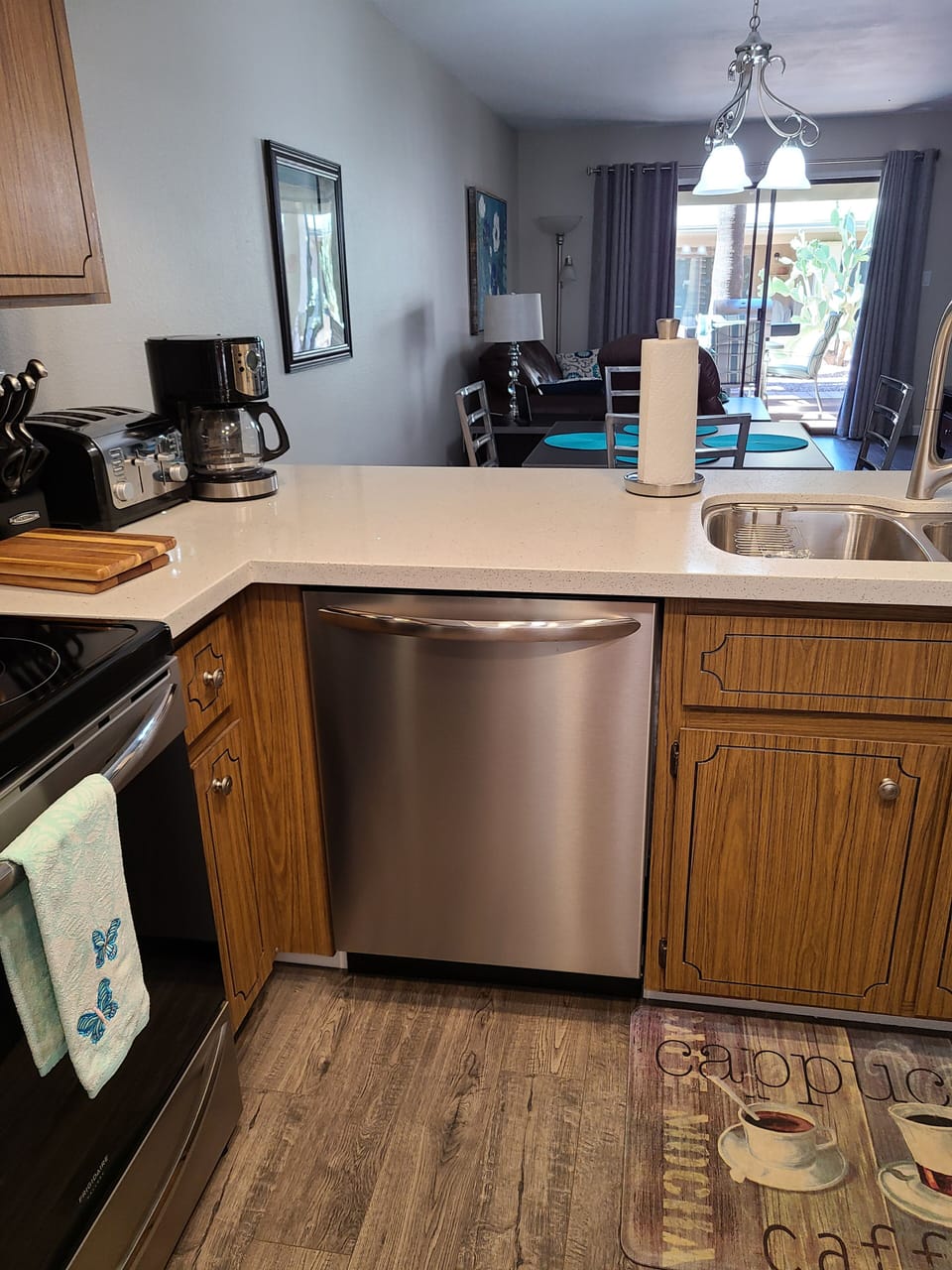 New stainless steel appliances and white quartz counter tops.