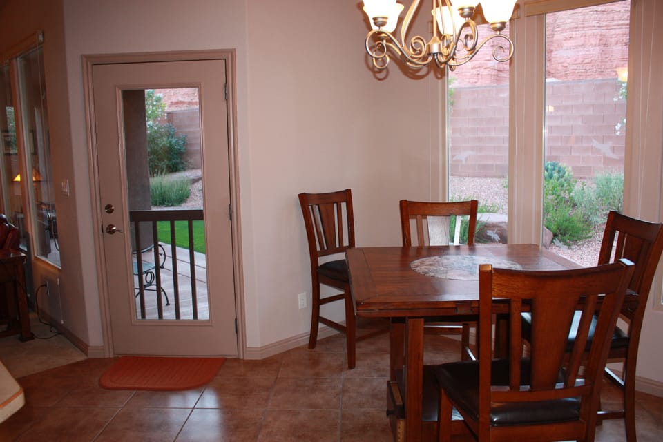Kitchen and dining area open to patio, with seating area.  