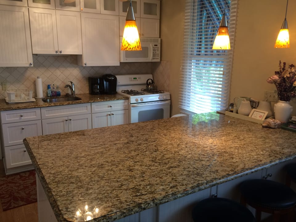 Granite counter with six stools.