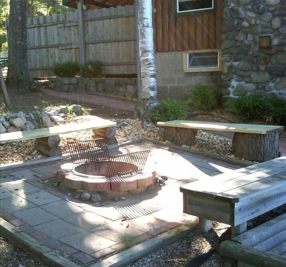 Firepit area, complete with cooking grates.  There is also a charcoal grill.