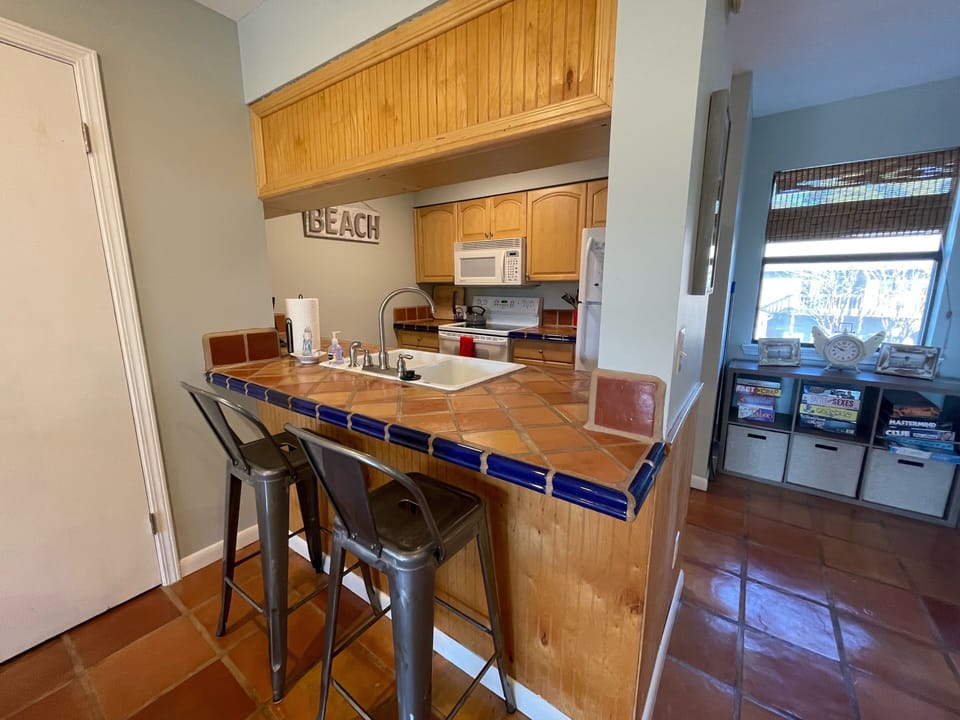Kitchen with two barstools. 
Plenty of board games available for your use! 